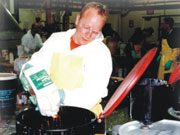 Picture of man properly disposing of household hazardous waste.